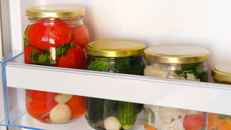 Pickle jars in a refrigerator 