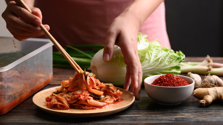 Person cooking with kimchi