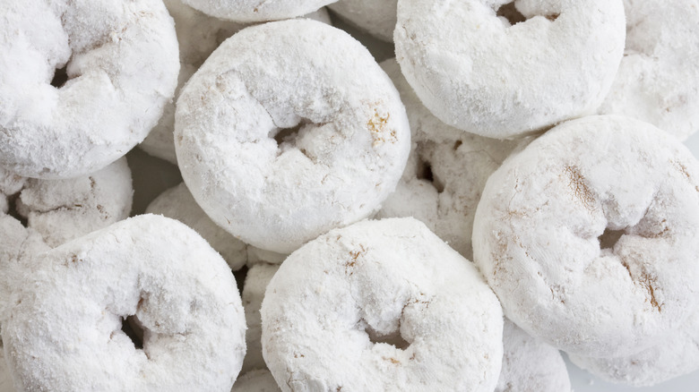 Powdered donuts in front of camera