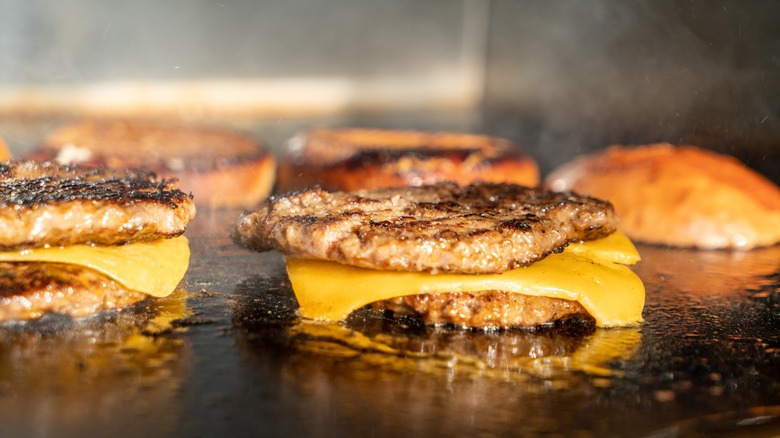 Double cheese burgers on grill