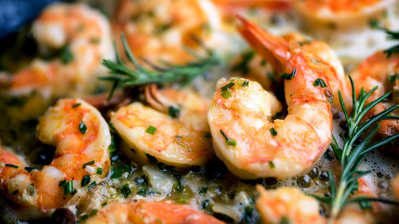 Buttery jumbo shrimps with a rosemary garnish