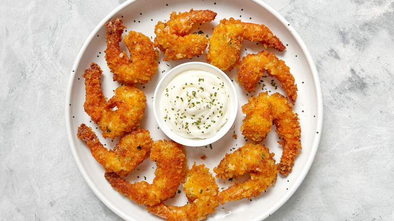 Fried shrimp on a plate with creamy dipping sauce