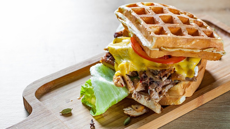 Waffle and meat sandwich with lettuce tomato and cheese