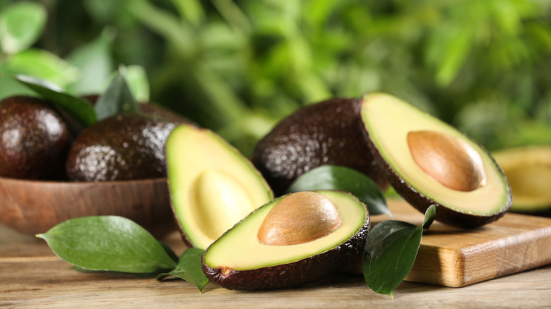 Halved avocados on outdoor table