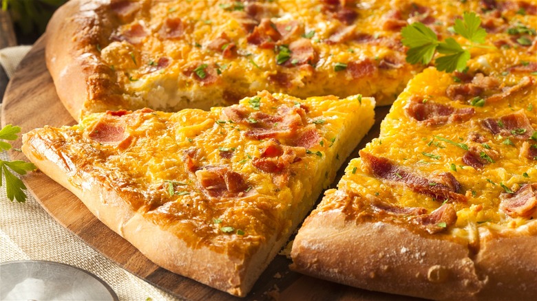 Pizza with eggs, bacon, and cheese 