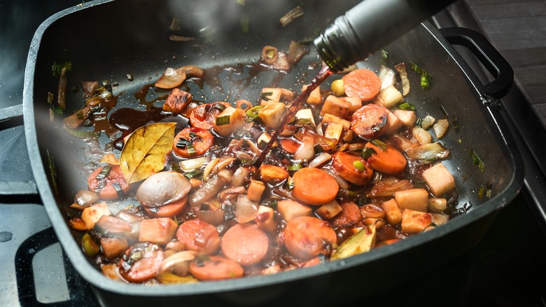 Wine deglazing pan with veggies