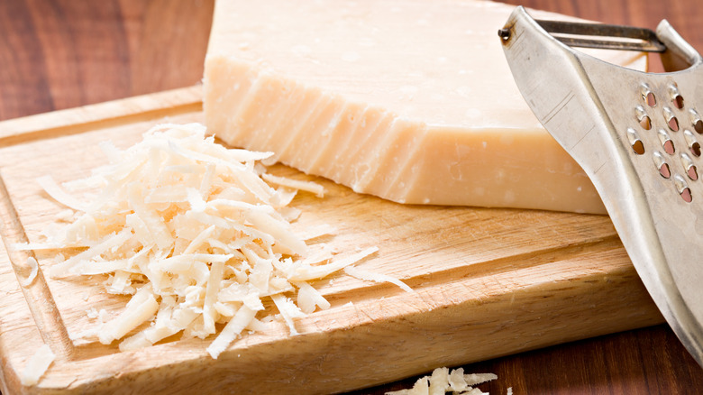 Shredded cheese on cutting board