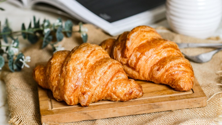 golden croissants on a wooden board