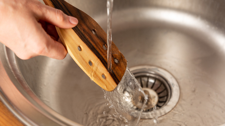 washing a wooden spoon