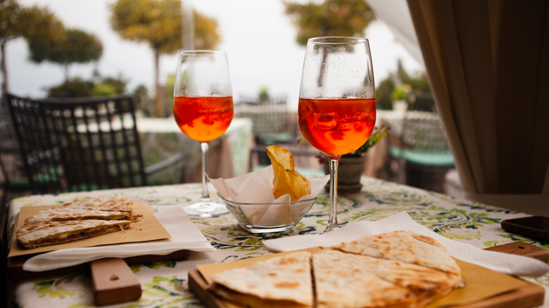 Two glasses of Aperol on a table