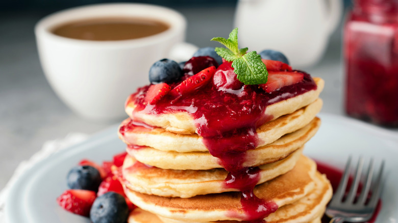 Pancakes topped with cranberry sauce and fruit