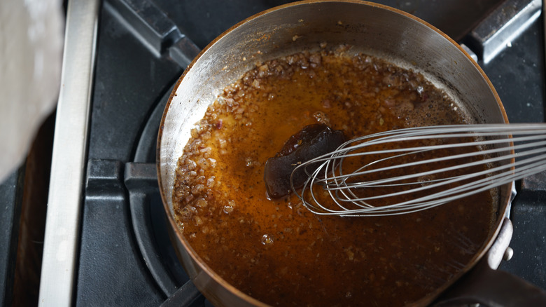 pan of sauce being deglazed