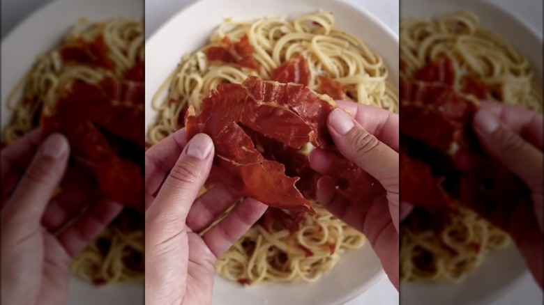 Prosciutto crumbled on pasta