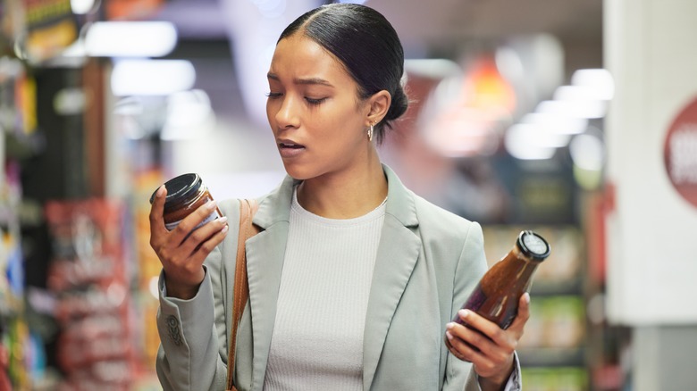 woman reading product labels in store