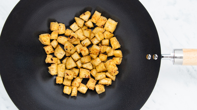 fried tofu chunks in pan