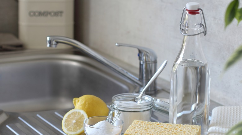 White vinegar and other cleaning products next to sink