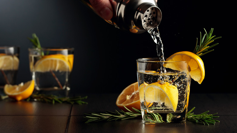 pouring lemon rosemary cocktail