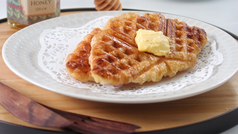 Waffled croissant French toast with butter on plate