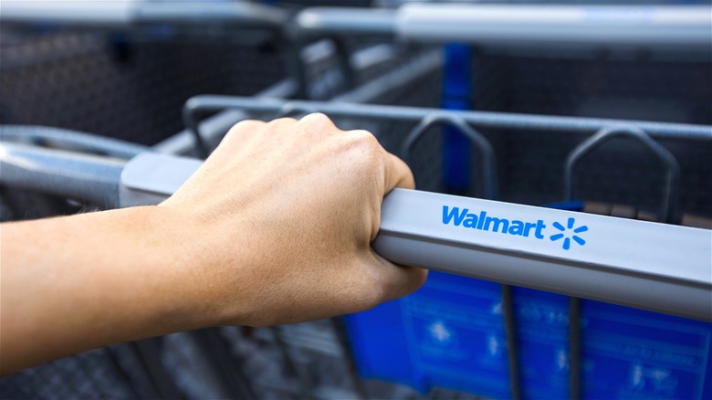 Hand on Walmart shopping cart 