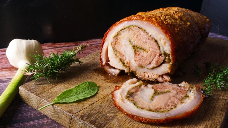 roast stuffed porchetta on wooden board