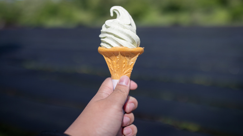 hand holding wasabi ice cream cone