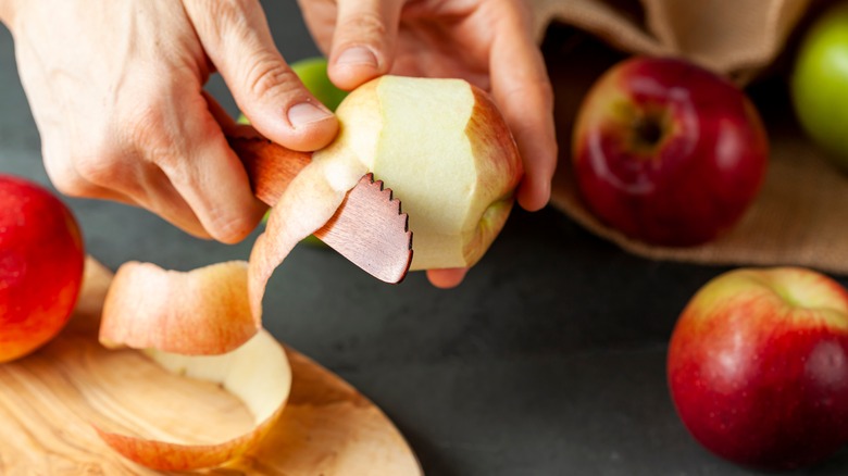 man peeling an apple