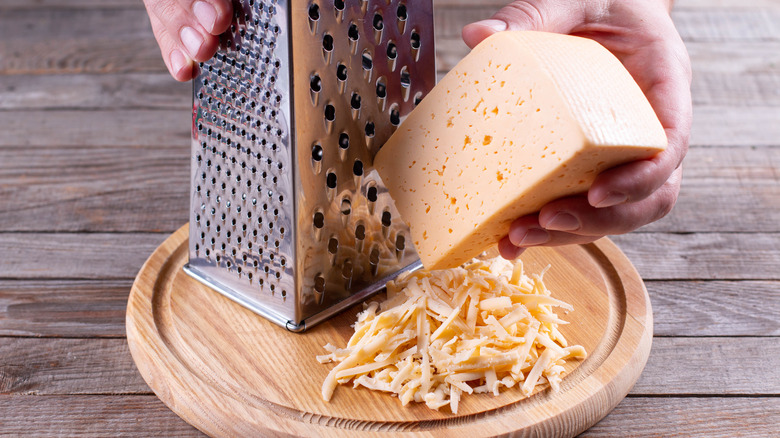 grating a wedge of cheese