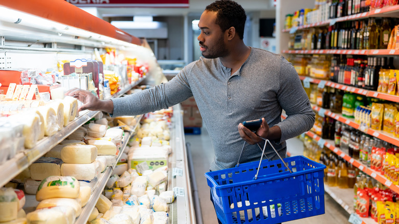 man shopping for cheese