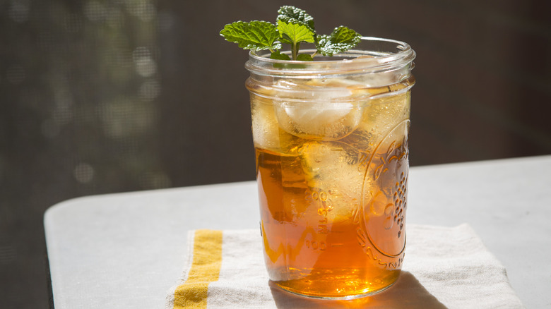 iced tea with mint leaves on table