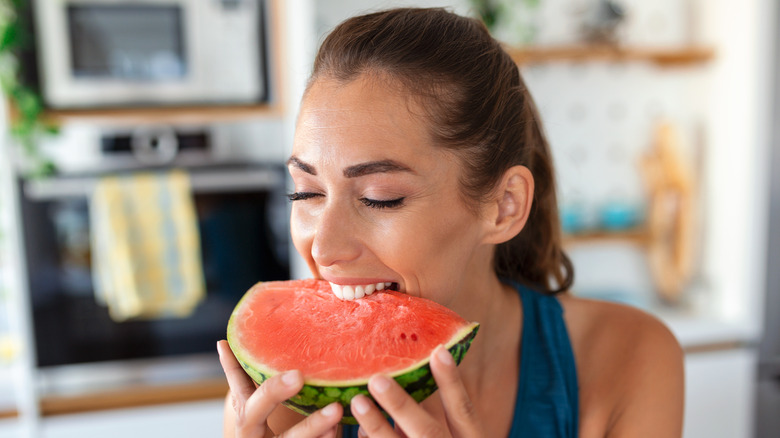 Woman eating a slice of watermelon