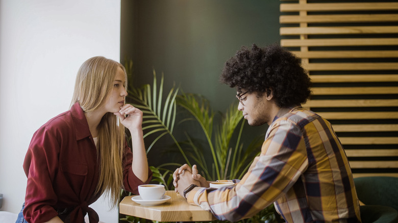 Couple looking awkward at cafe