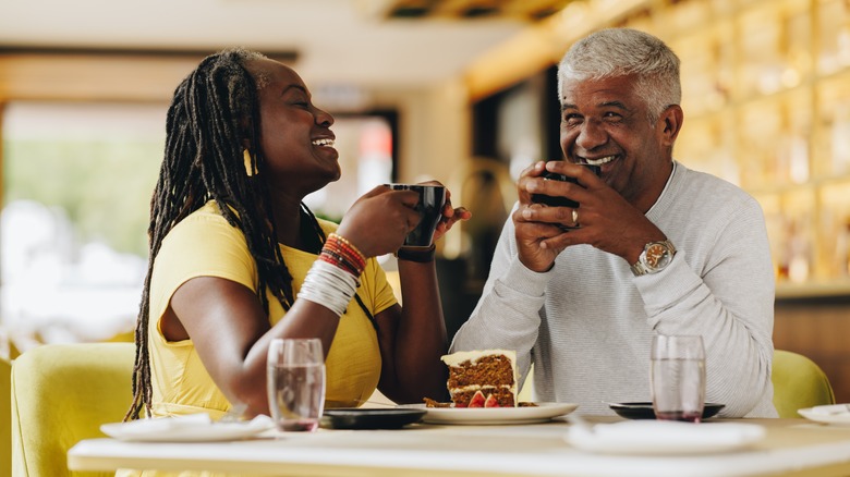 Couple laughing over coffee