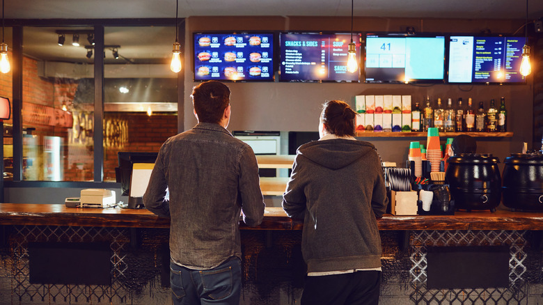 Two men at fast food counter