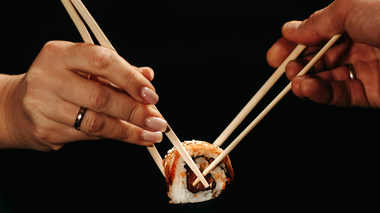 Couple eating the same sushi