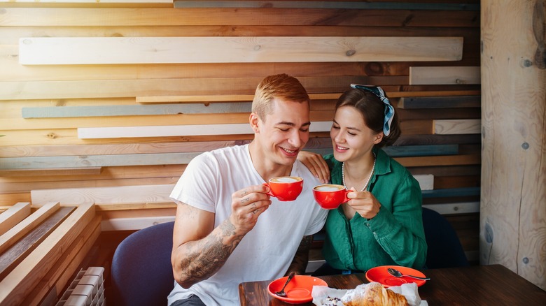 Couple sitting together at cafe