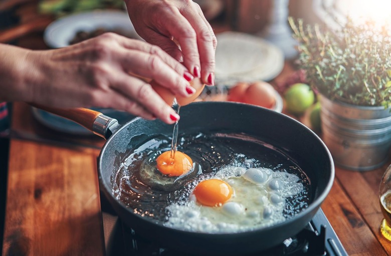 By cooking eggs and delicate fish filets in it