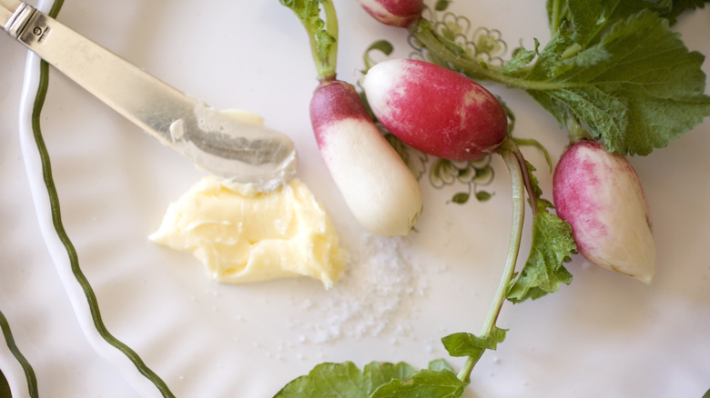 Radishes and butter on plate