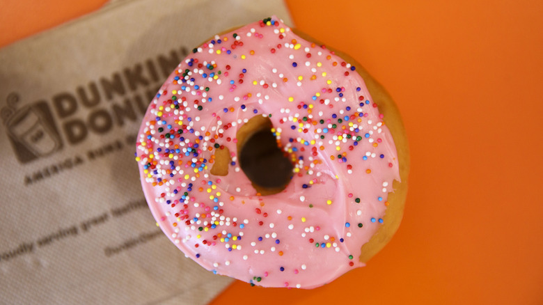 Strawberry frosted doughnut with sprinkles on Dunkin napkin