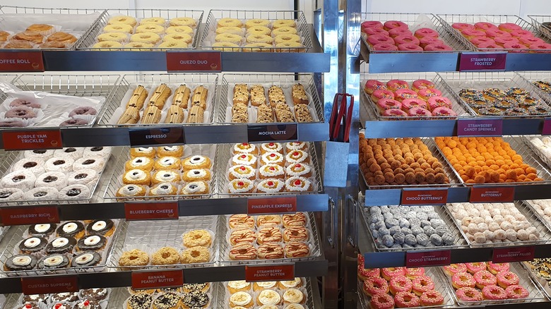 Racks of various doughnuts on display