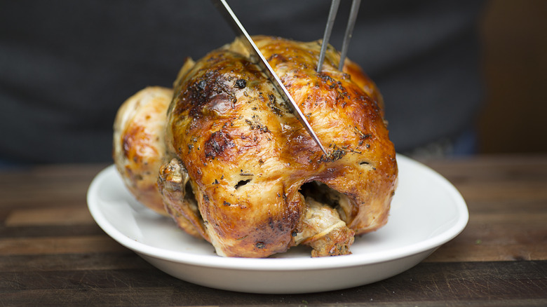 Rotisserie chicken being carved