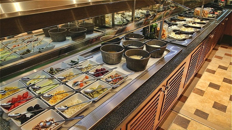 Salad bar bowls of toppings 