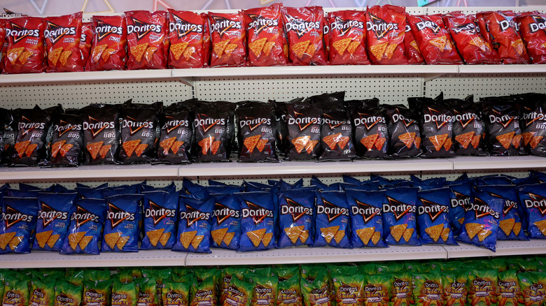 grocery store shelf filled with bags of doritos