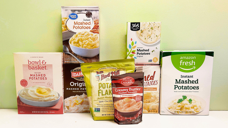 Eight brands of instant mashed potatos stacked together against a light green background