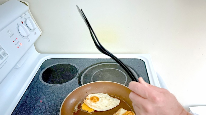 Hand holding egg spatula