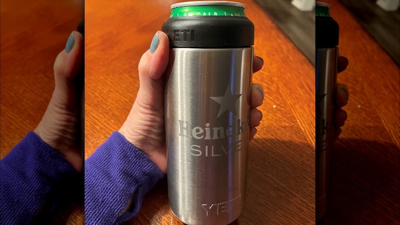 Closeup of hand holding Heineken in Yeti