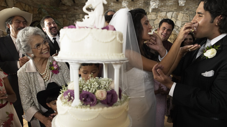 Couple with their wedding cake