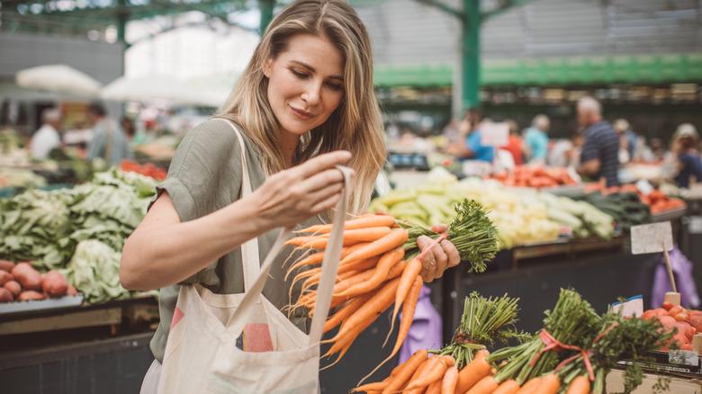 Woman buying seasonal vegetables