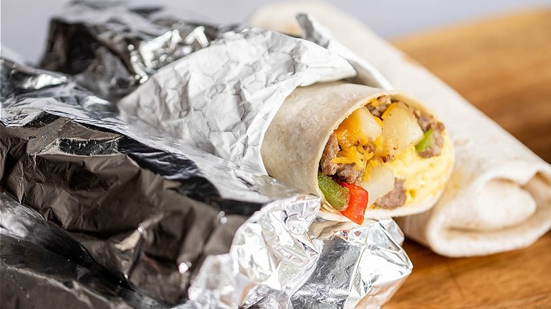 burritos wrapped in foil on board
