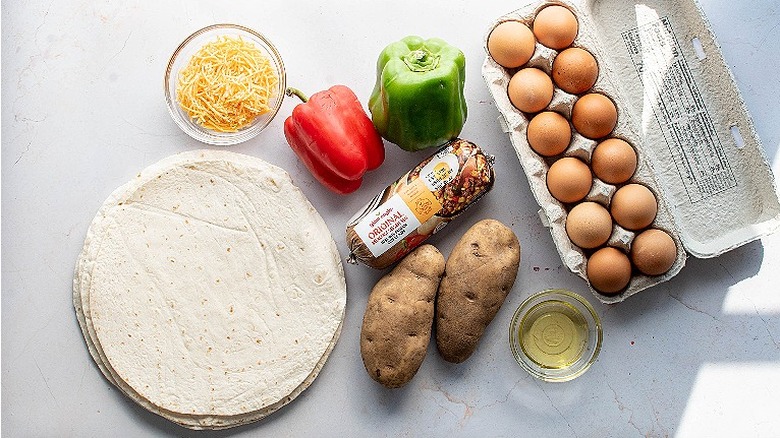 ingredients for breakfast burrito on a table