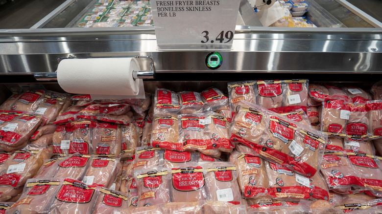 A Costco cooler filled with bags of boneless, skinless chicken breasts